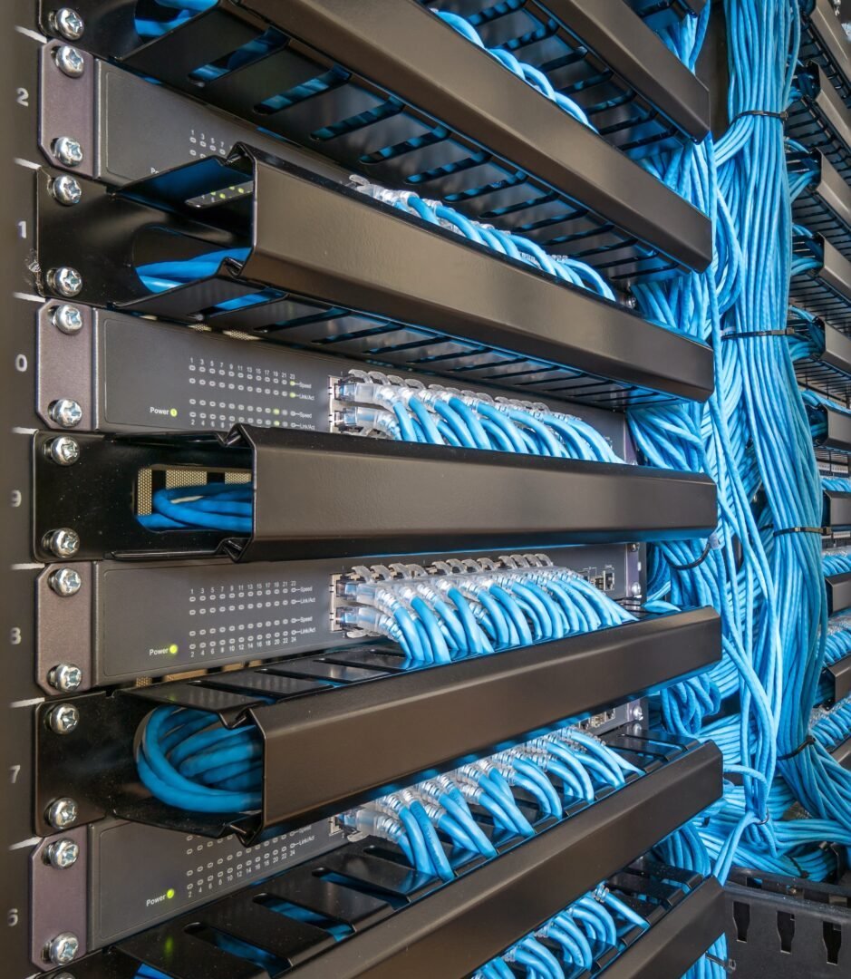 Network,Switch,Hub,And,Ethernet,Cables,In,Rack,Cabinet